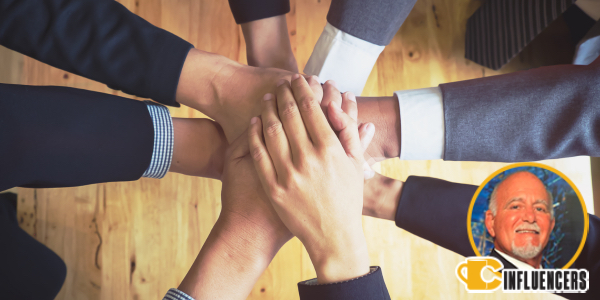 Hands together in a teamwork huddle, Joe Sorrentino’s headshot in the bottom right